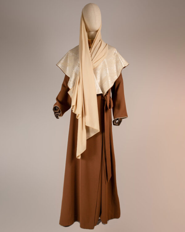 "Desert Radiance Abaya in light caramel with a shimmering golden shawl collar, featuring a flowing silhouette for elegance and comfort."